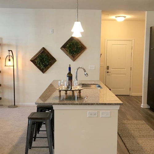 a kitchen with an island and connected dining room
