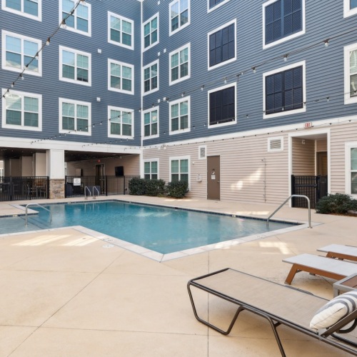 Resort-style swimming pool with lounge seating